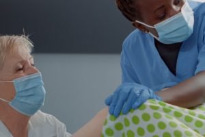 Multi ethnic medical team supporting woman giving birth Multi ethnic medical team supporting woman giving birth